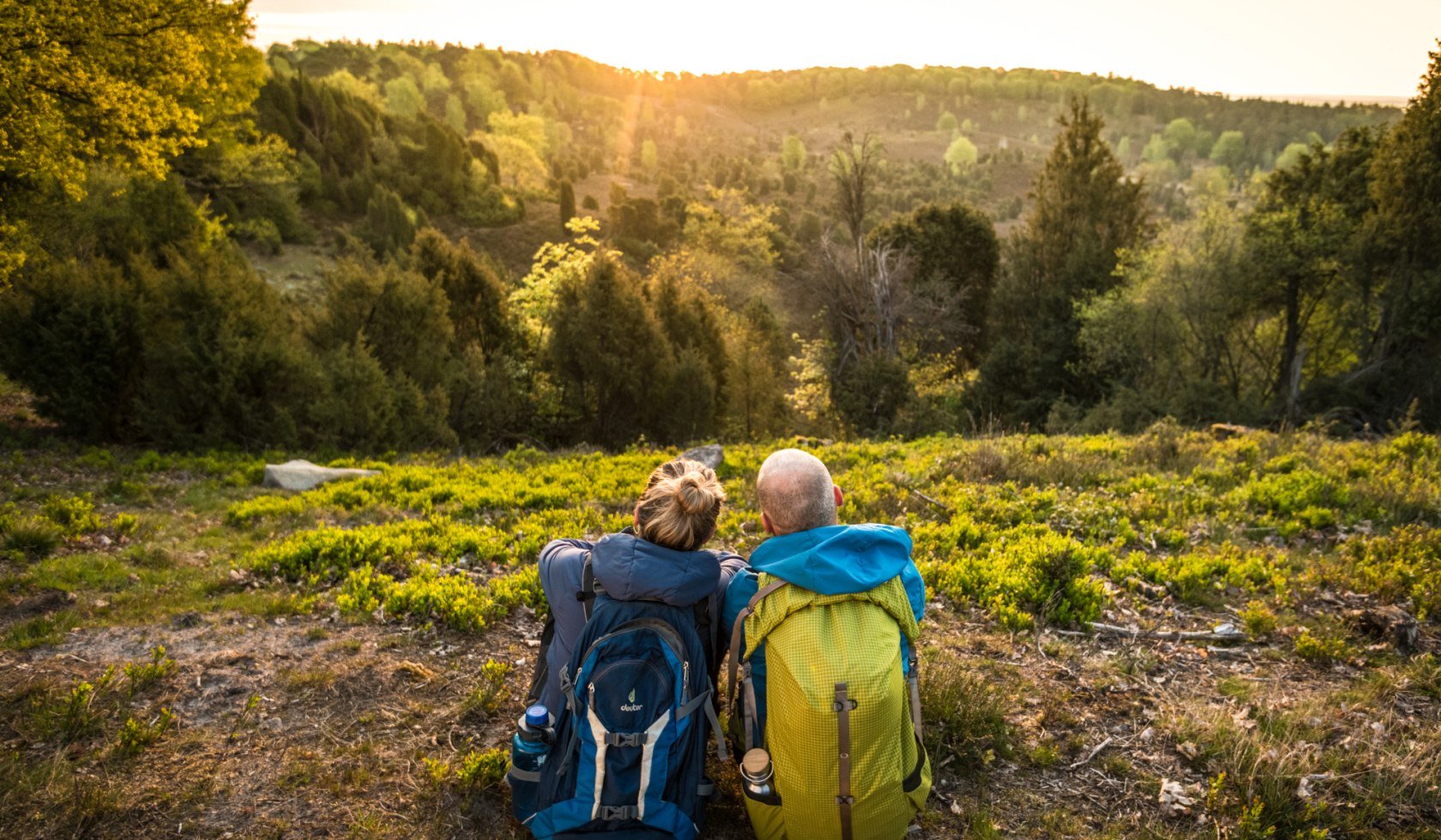 two hikers seen from behind during a break in the Lüneburger Heide , © Lüneburger Heide GmbH