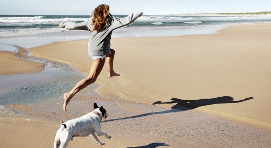 Woman with dog on the beach campaign 2020