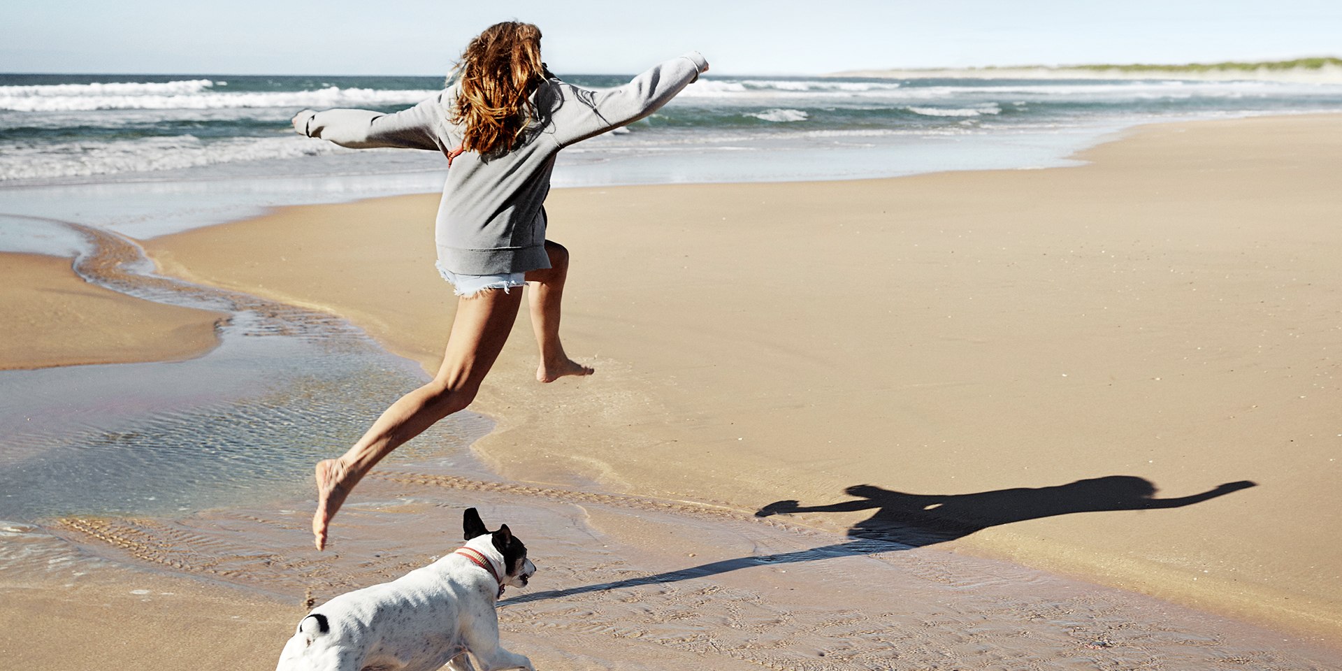 Woman with dog on the beach campaign 2020