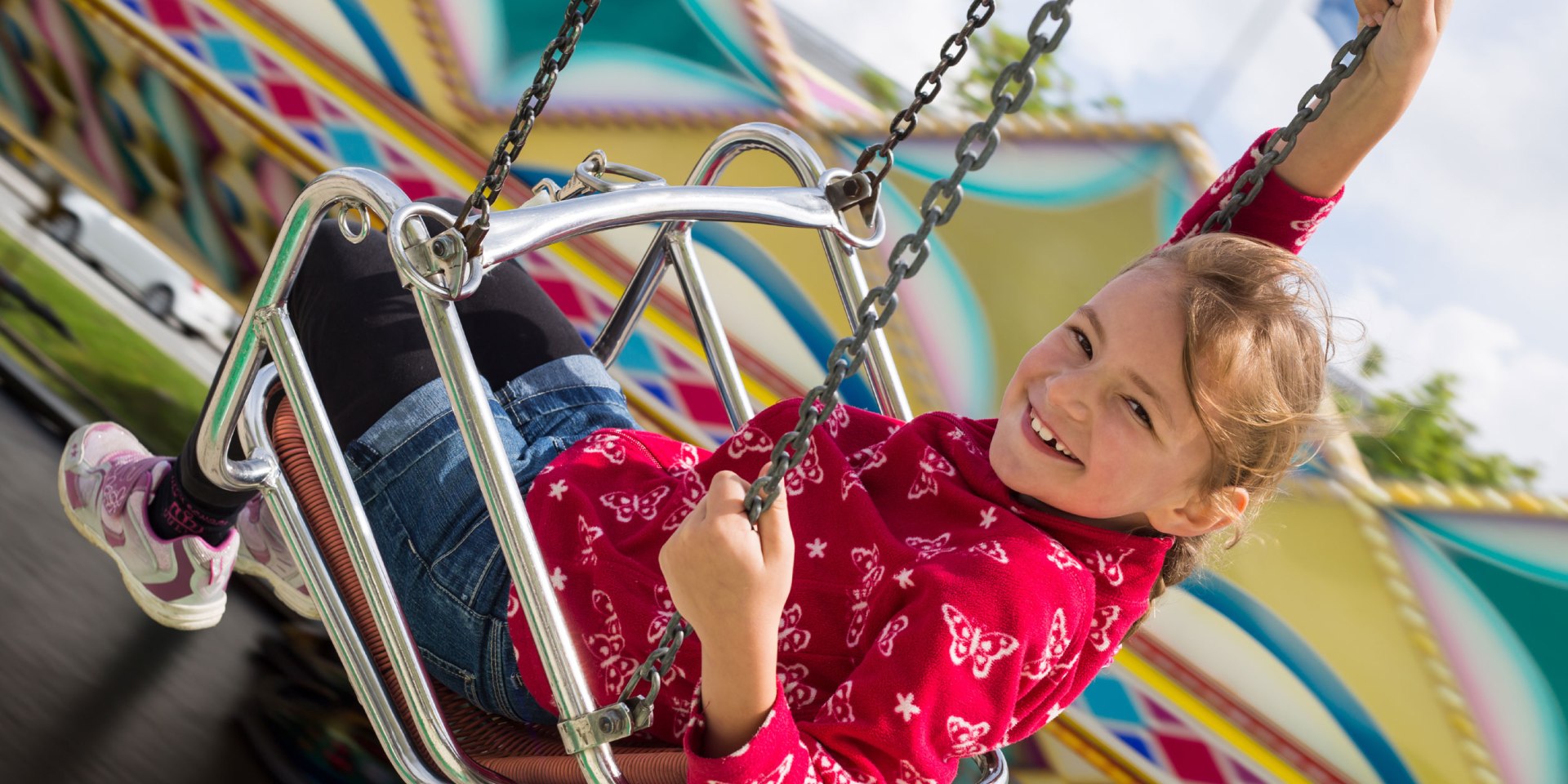 A girl has fun in the chain carousel, © Fotolia / Stefanie B.